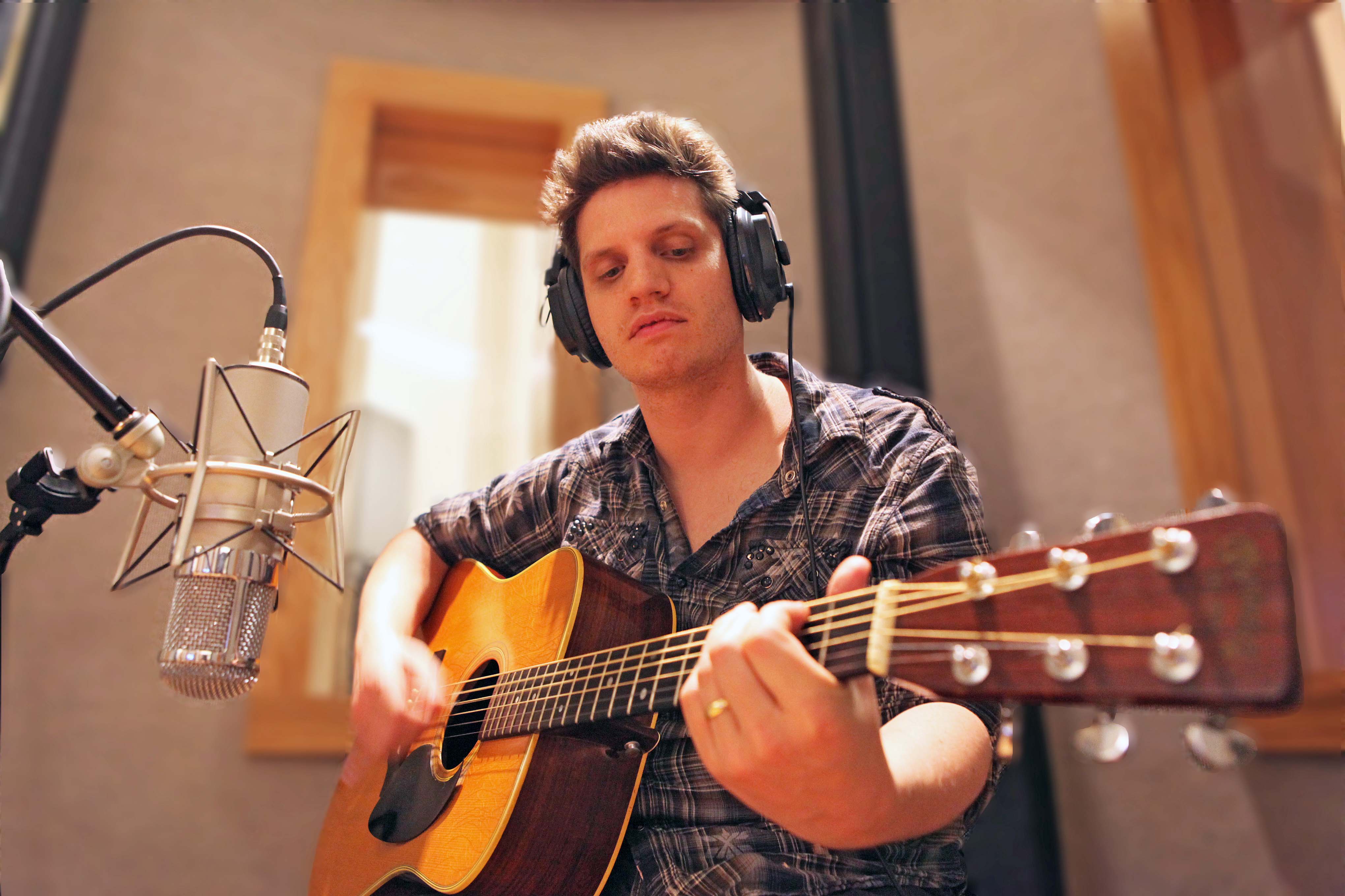 Student recording sound from a guitar.