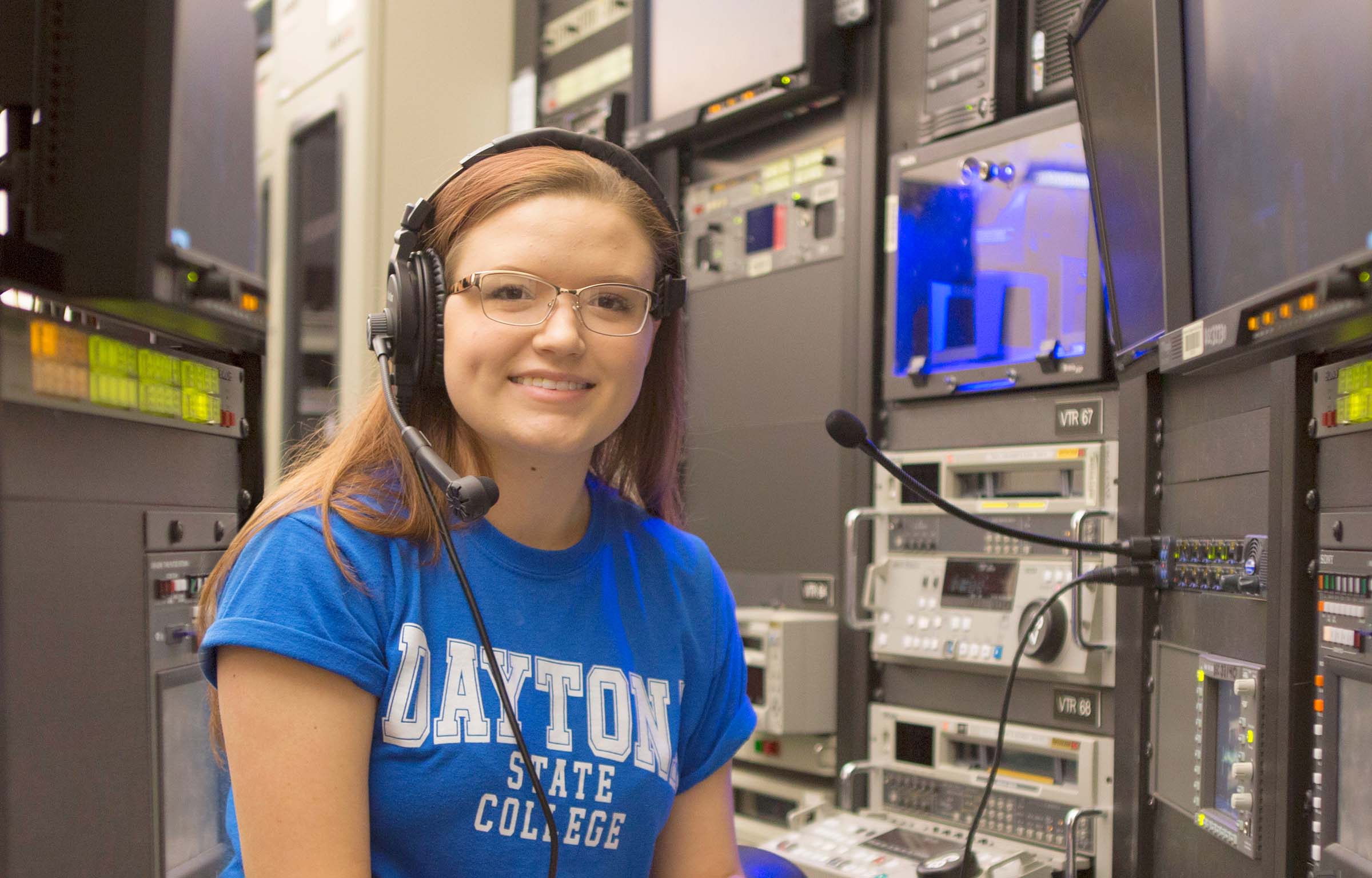 student in blue shirt wearing headphones