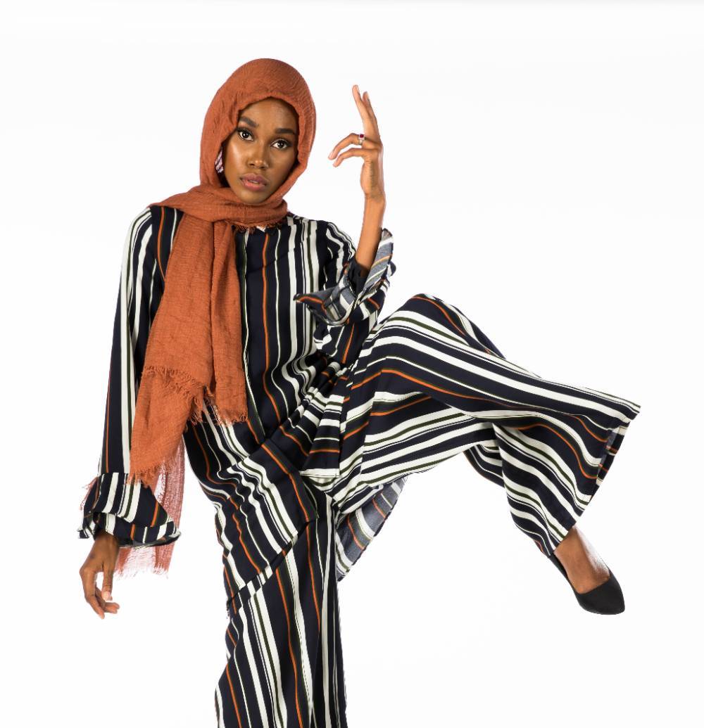 model in striped outfit in orange head wrap