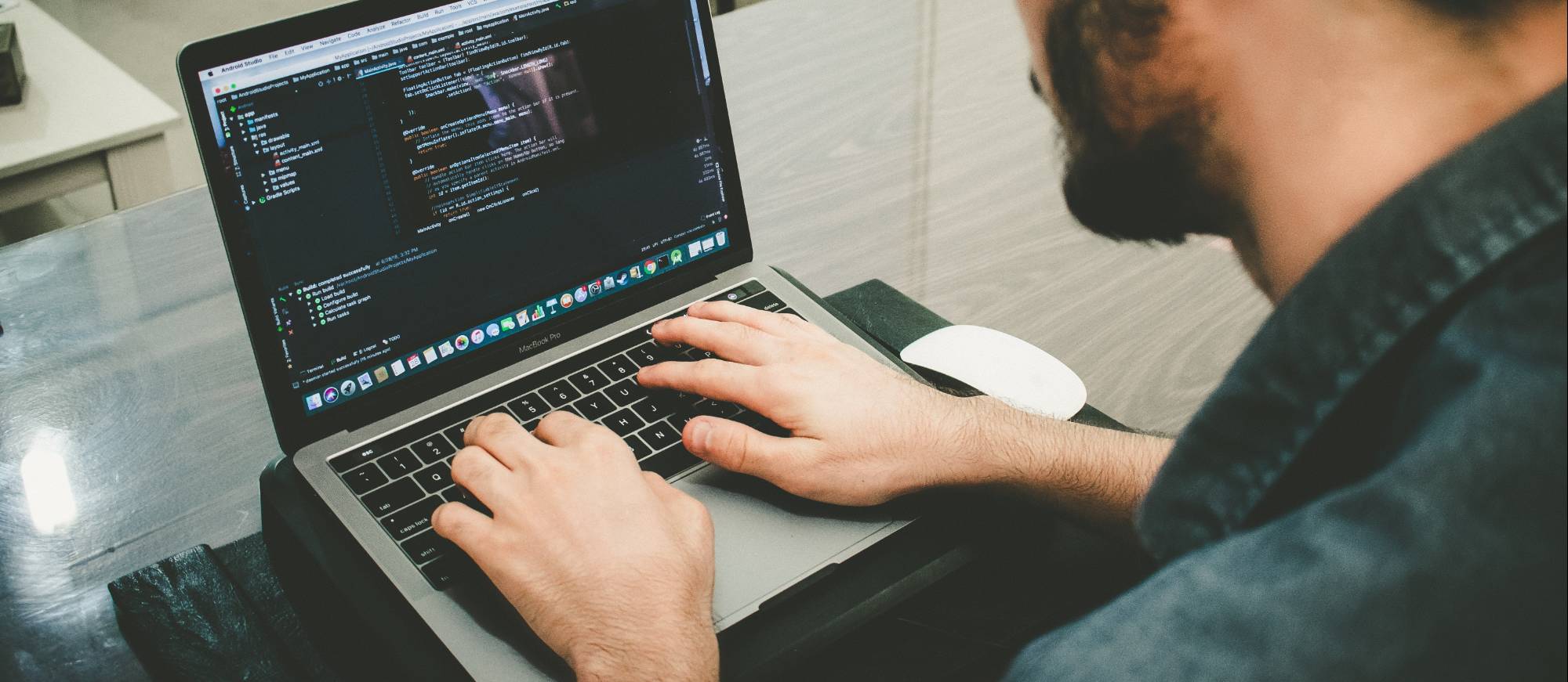 person programming on a laptop