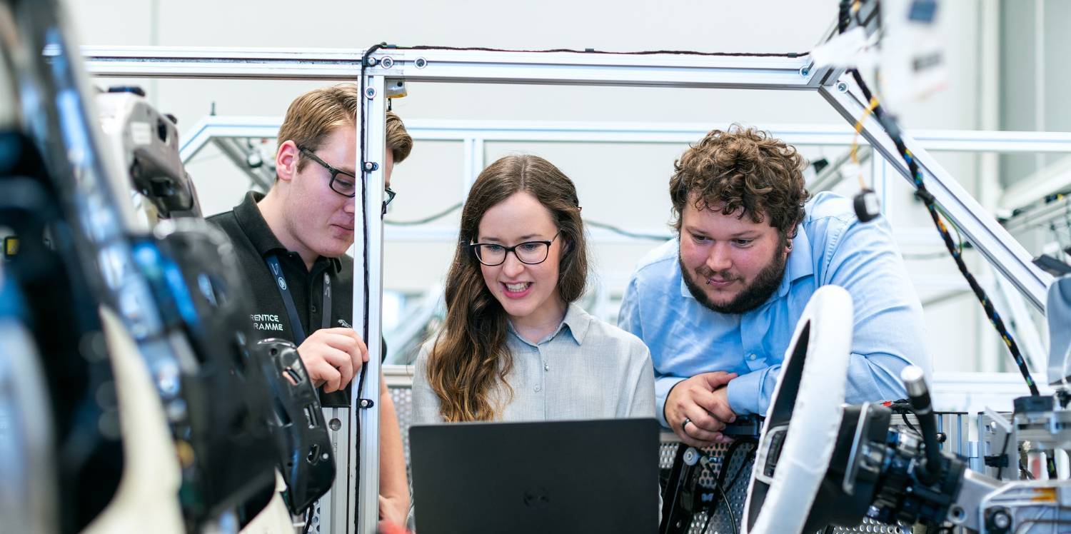 three engineering working on a laptop