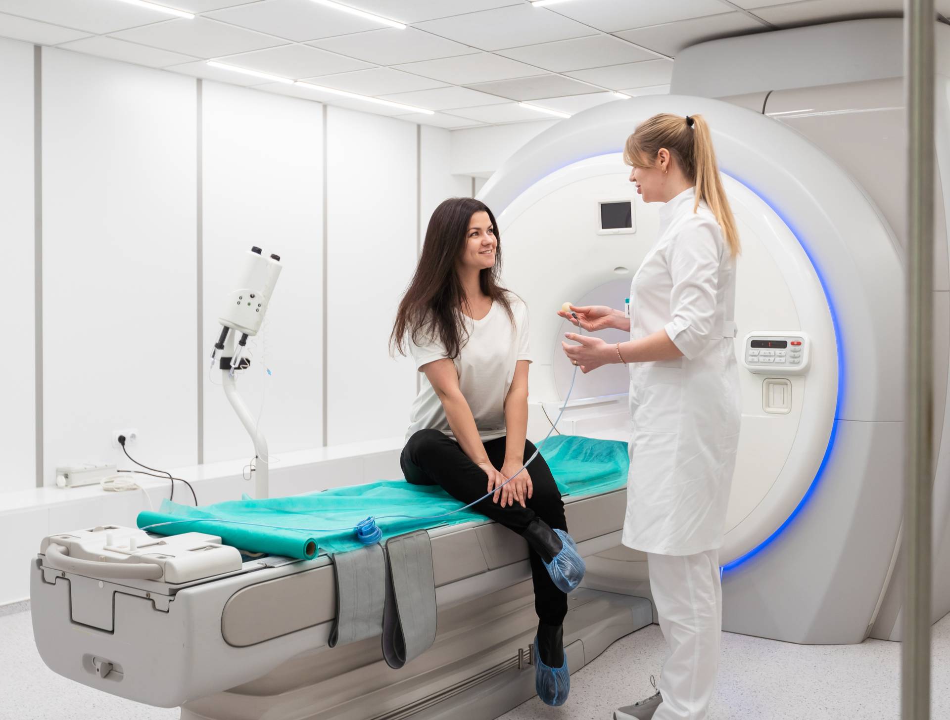 Two people with an MRI machine. 