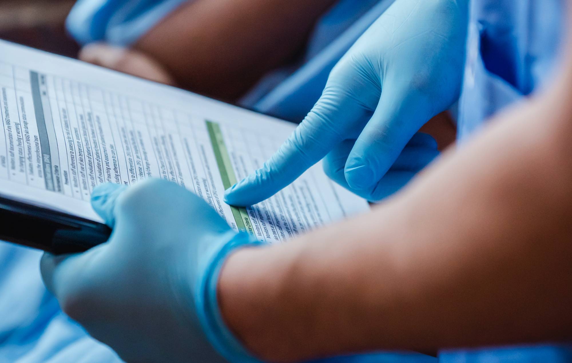 nurse holding chart with patient