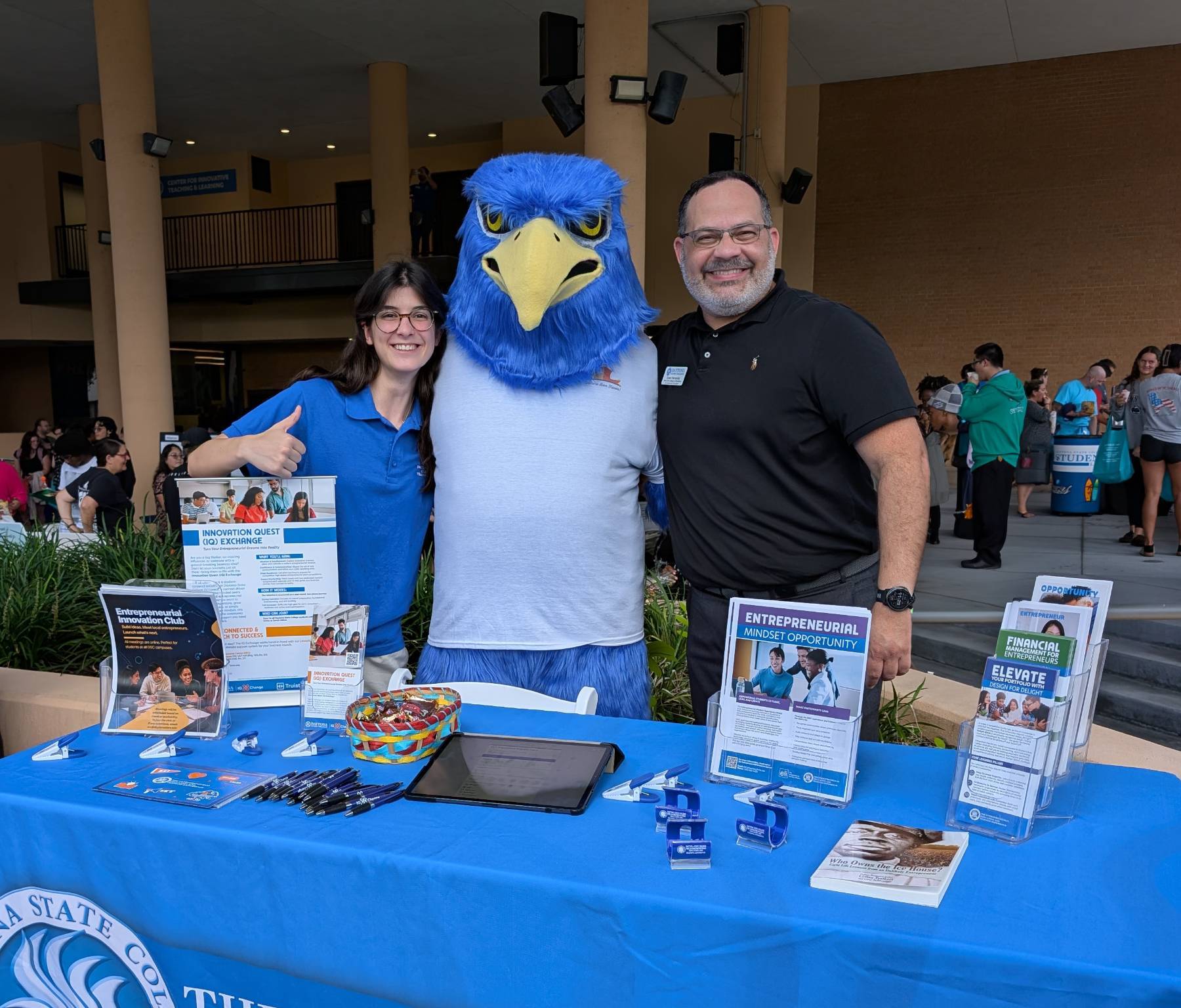 Freddie Falcon and the Entrepreneurial Education and Training Experience team hosting a table at the Welcome Back event. 