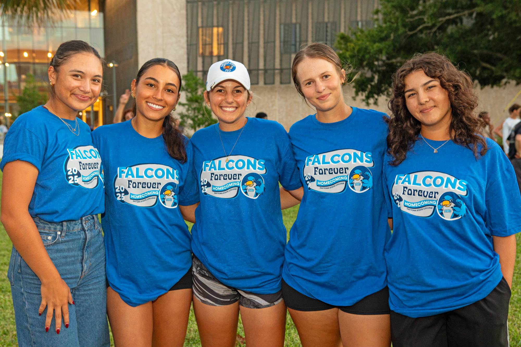 A group of students wearing matching homecoming shirts on campus. 