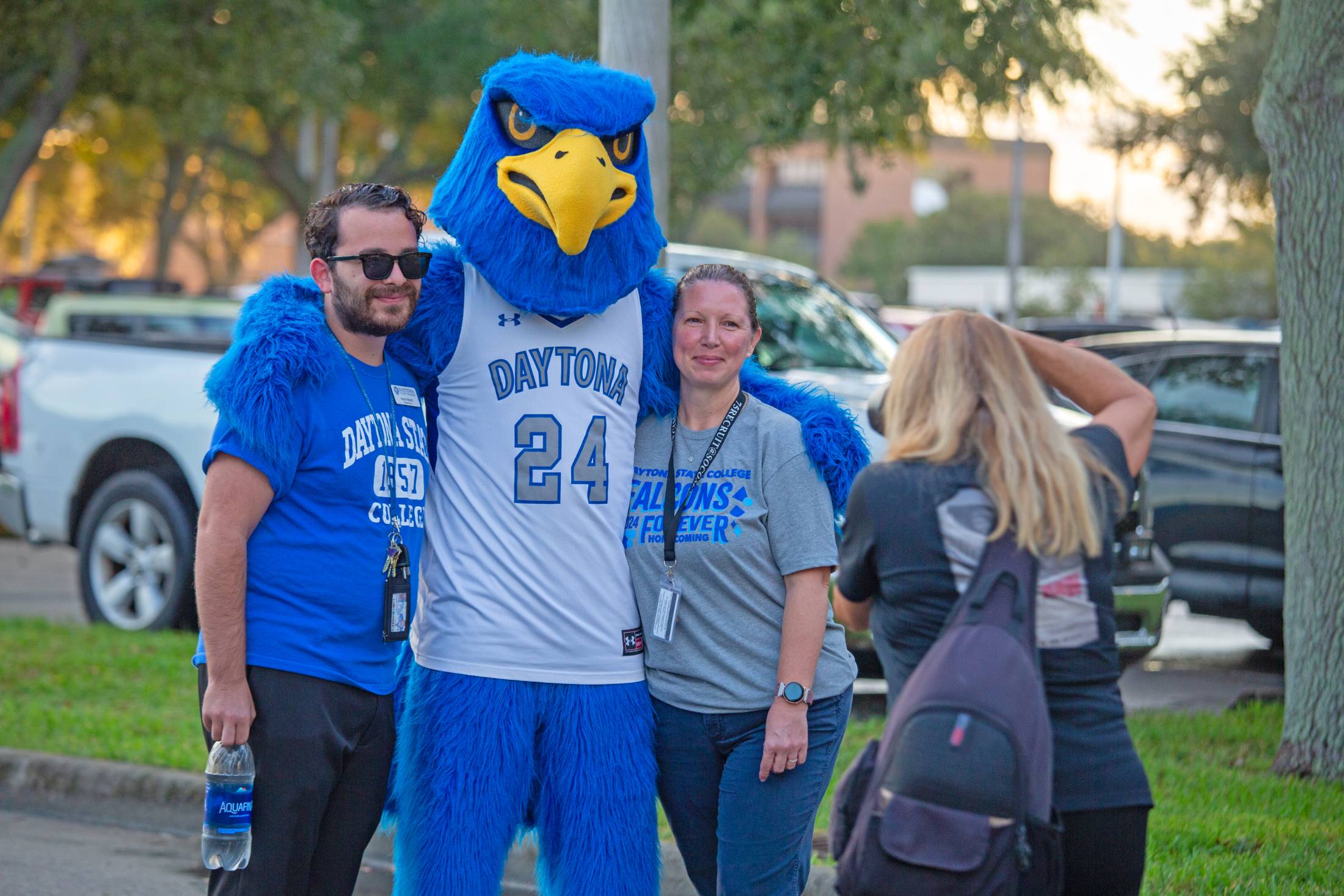 Freddie Falcon with students at Homecoming. 