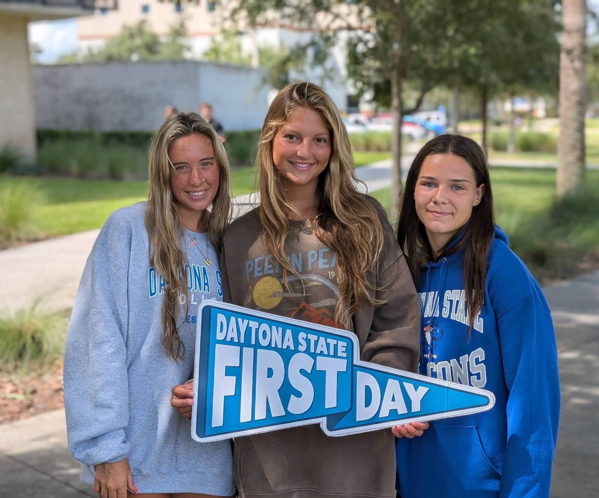 Three students on campus. 