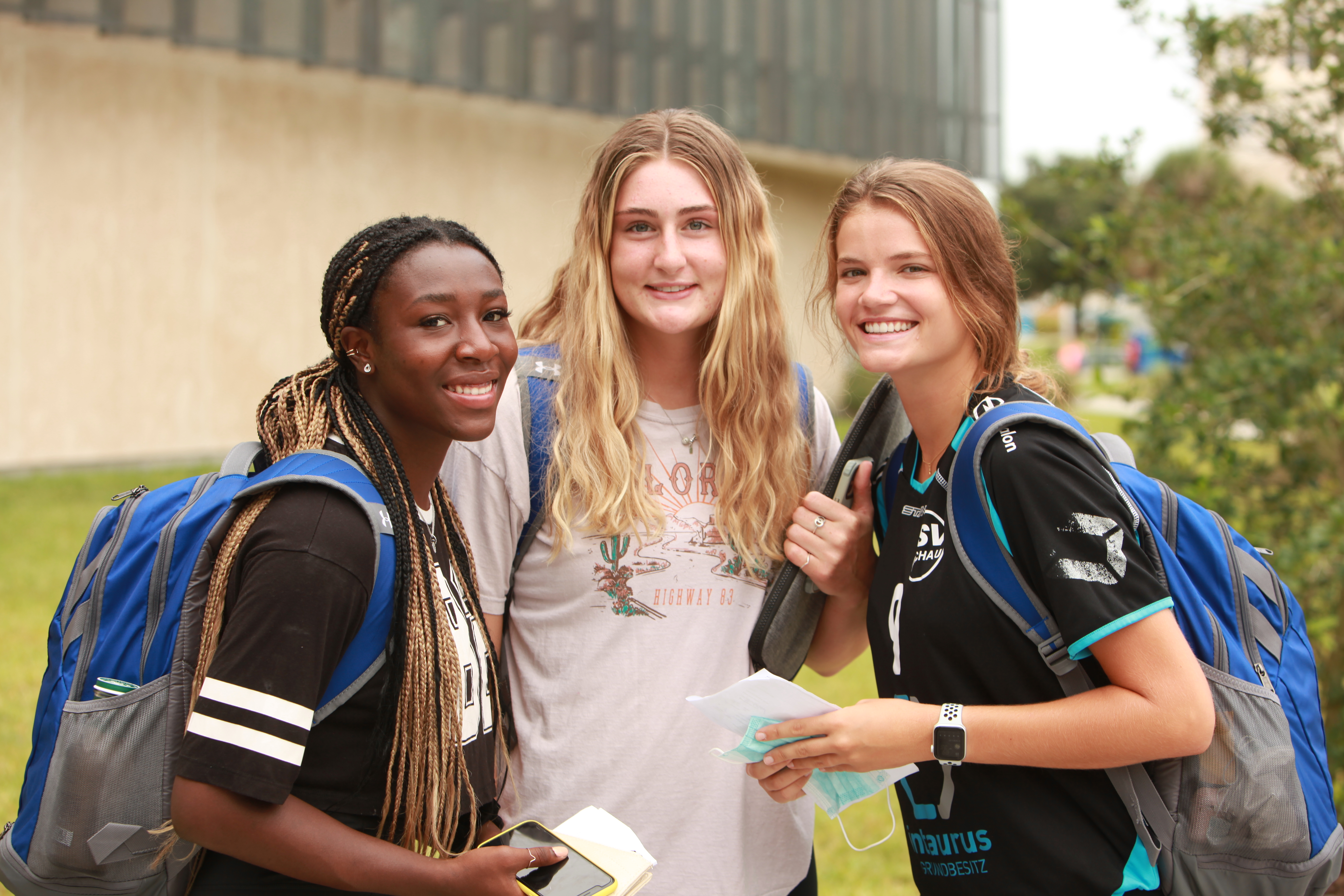 Three students on campus. 