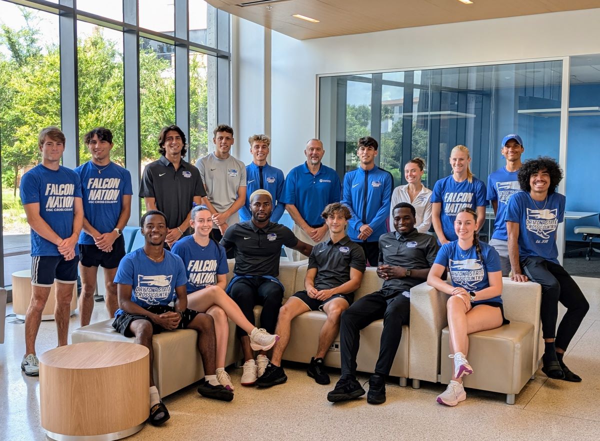 A group of 16 DSC athletes posing as a group in the Lemerand Student Center with Dr. Labosso