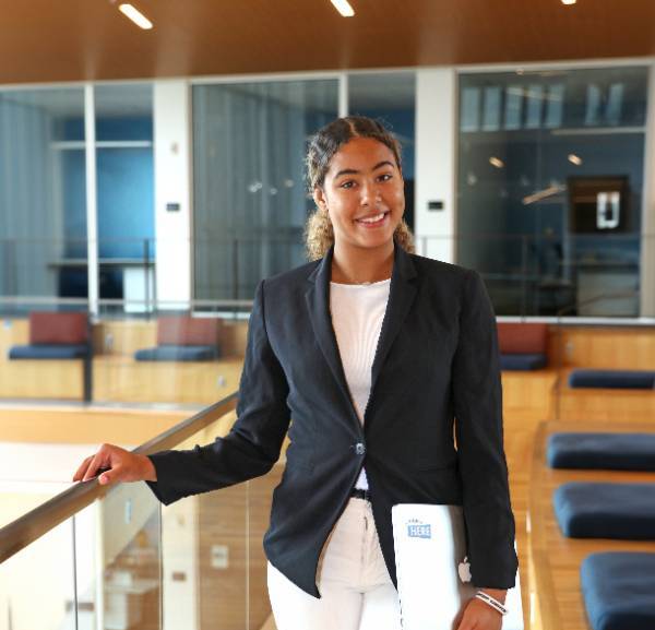 A student wearing business casual professional attire in the Student Center. 