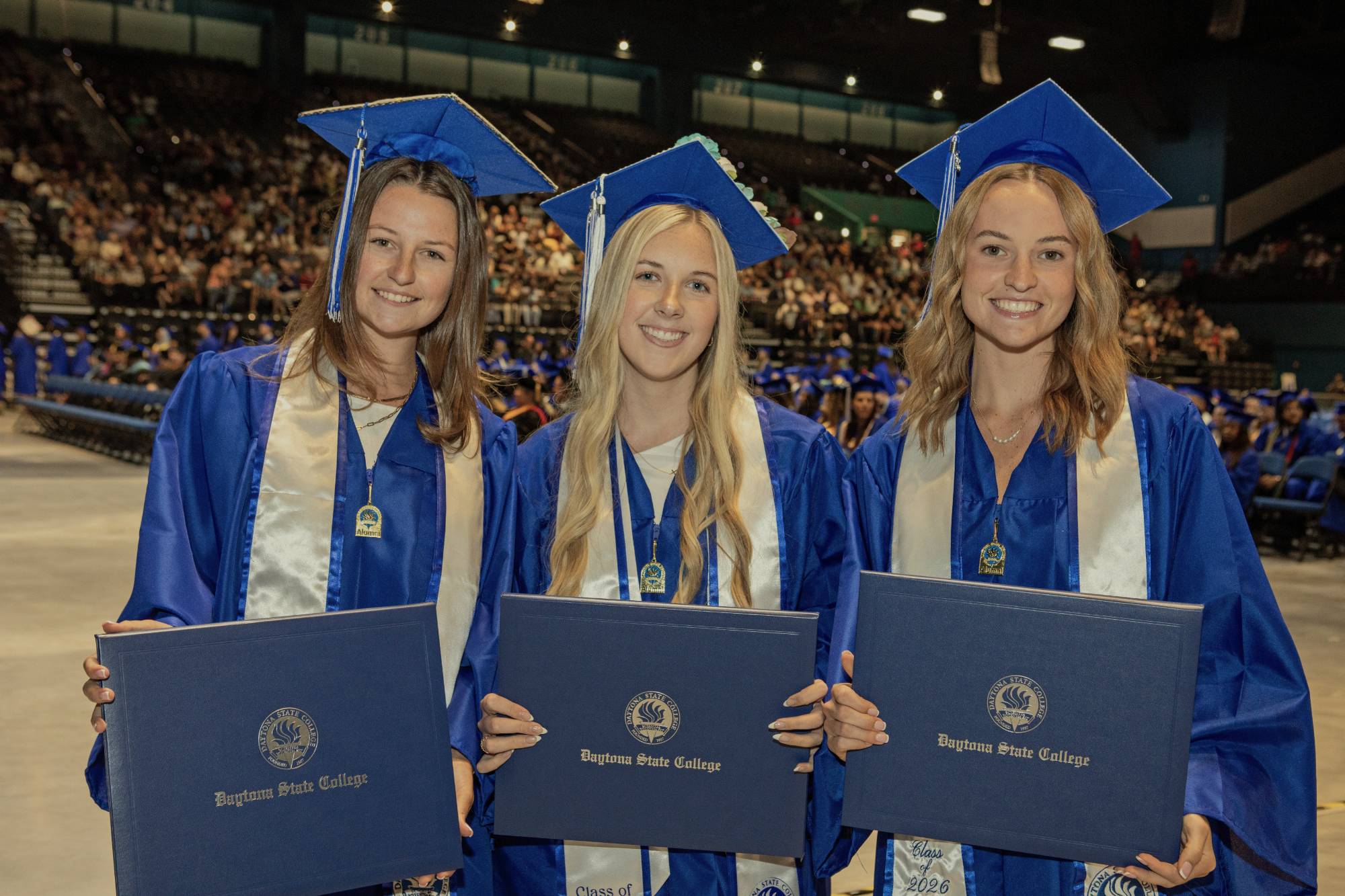 Two students decorate their caps for graduation. 