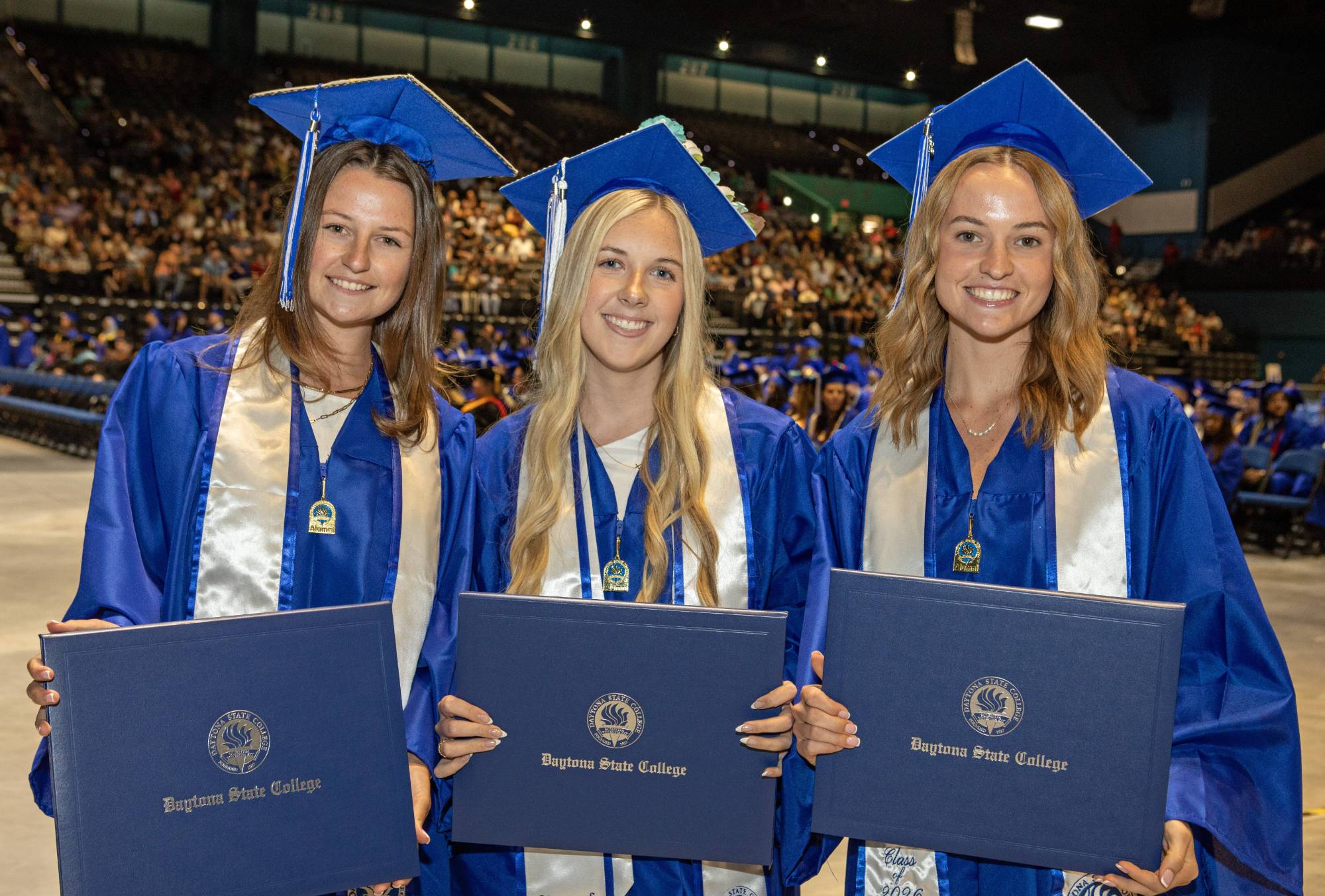 Two students decorate their caps for graduation. 