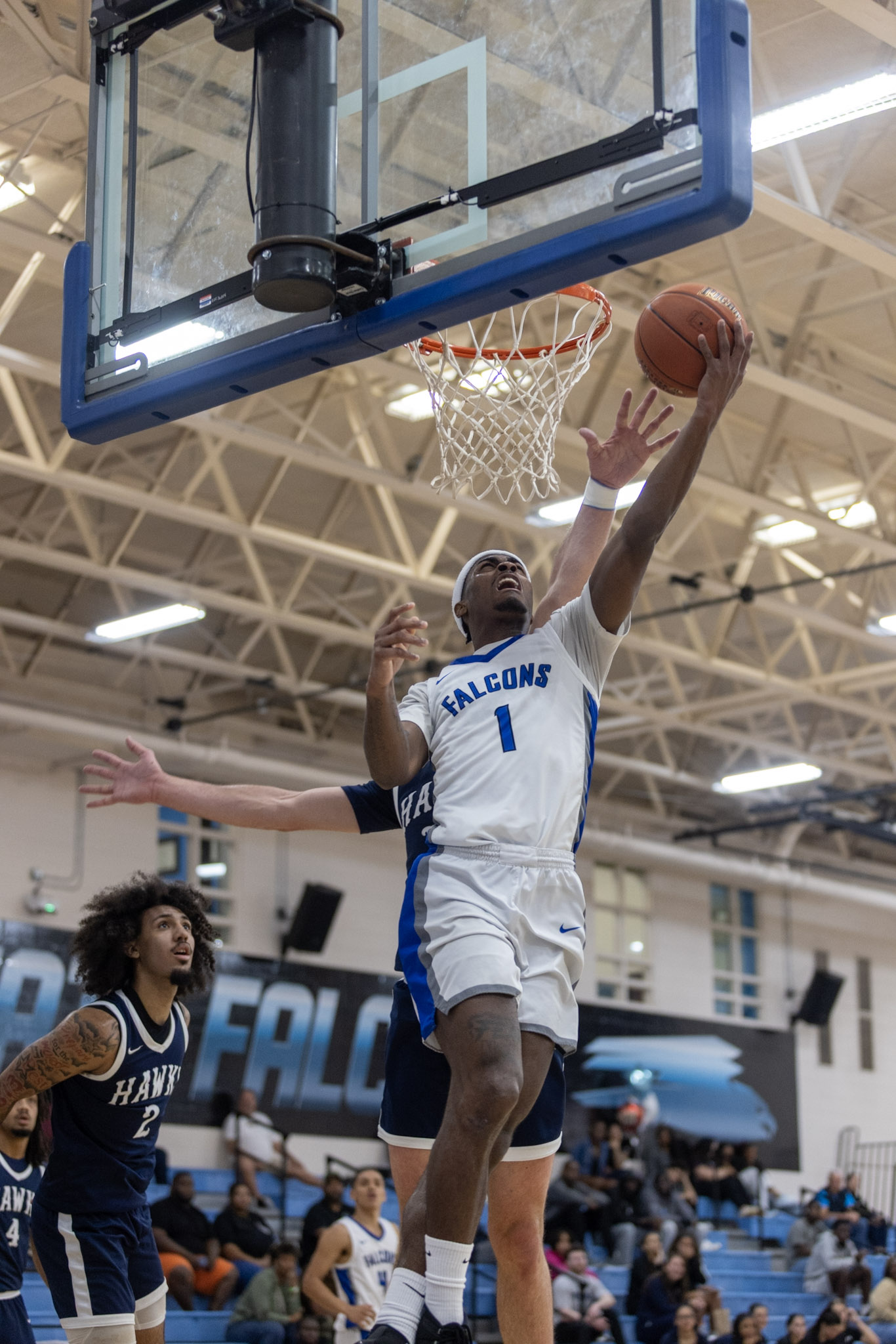 Men's basketball player about to score. 