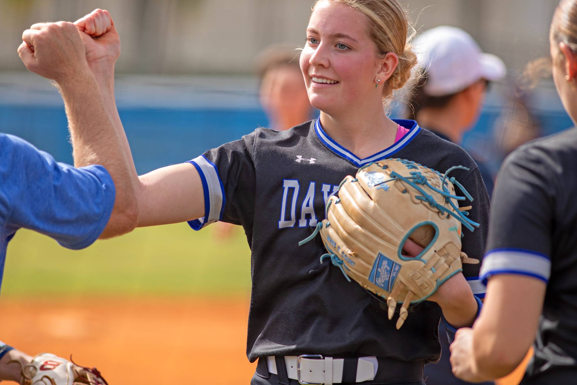 A softball player celebrates a good play. 