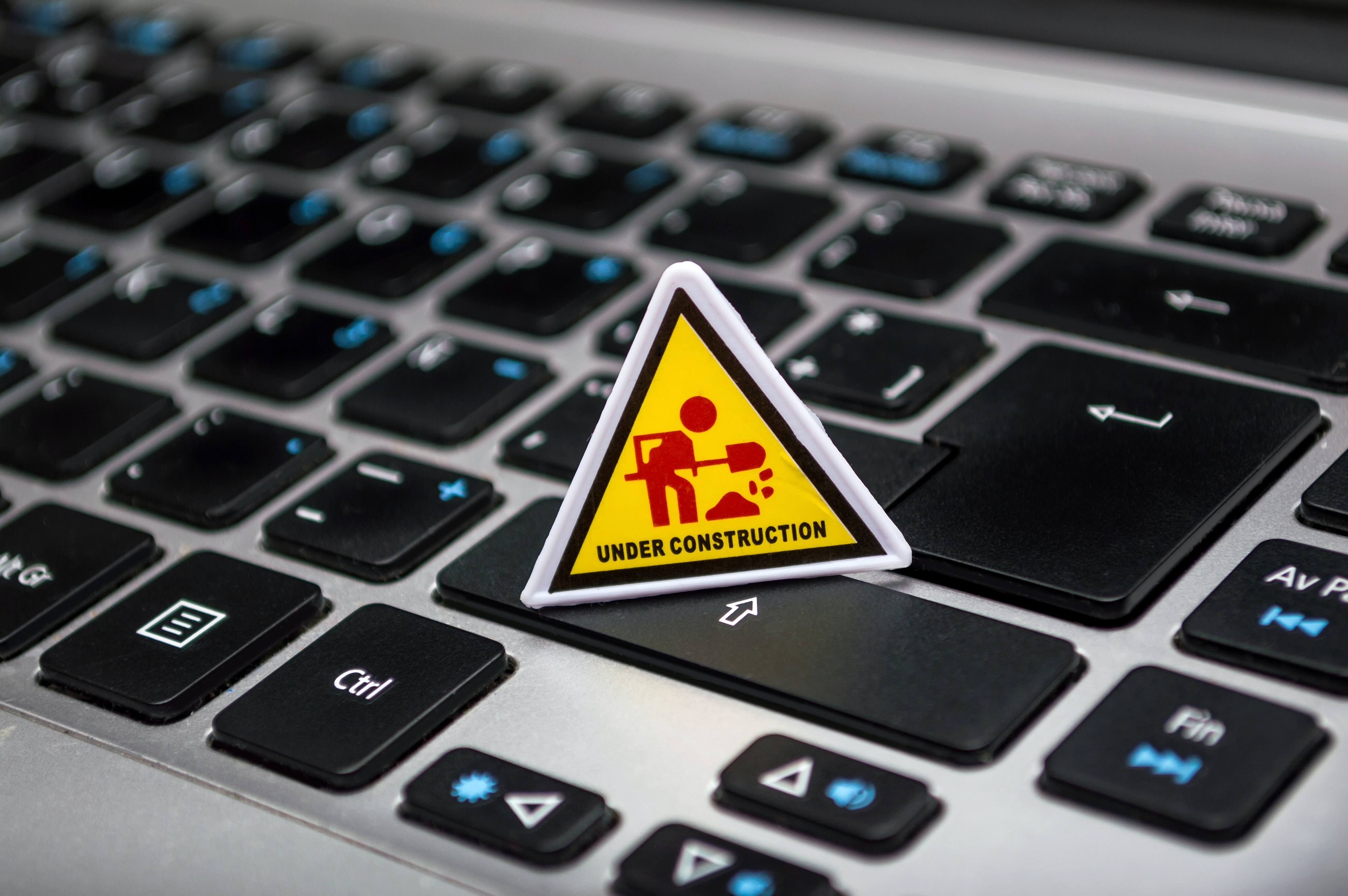 under construction sign on laptop keyboard