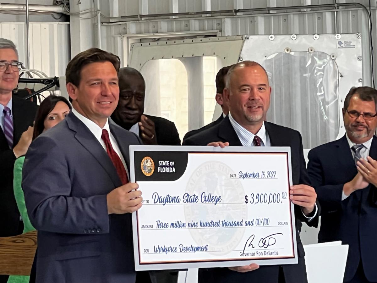 Gov. Ron DeSantis presenting check to DSC