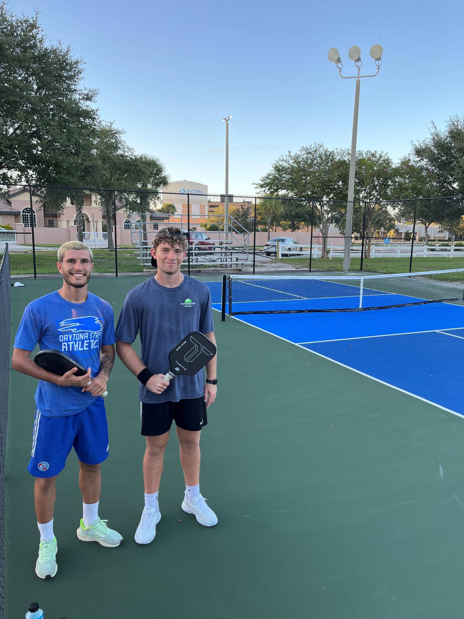 Two students playing on the new campus pickleball courts. 