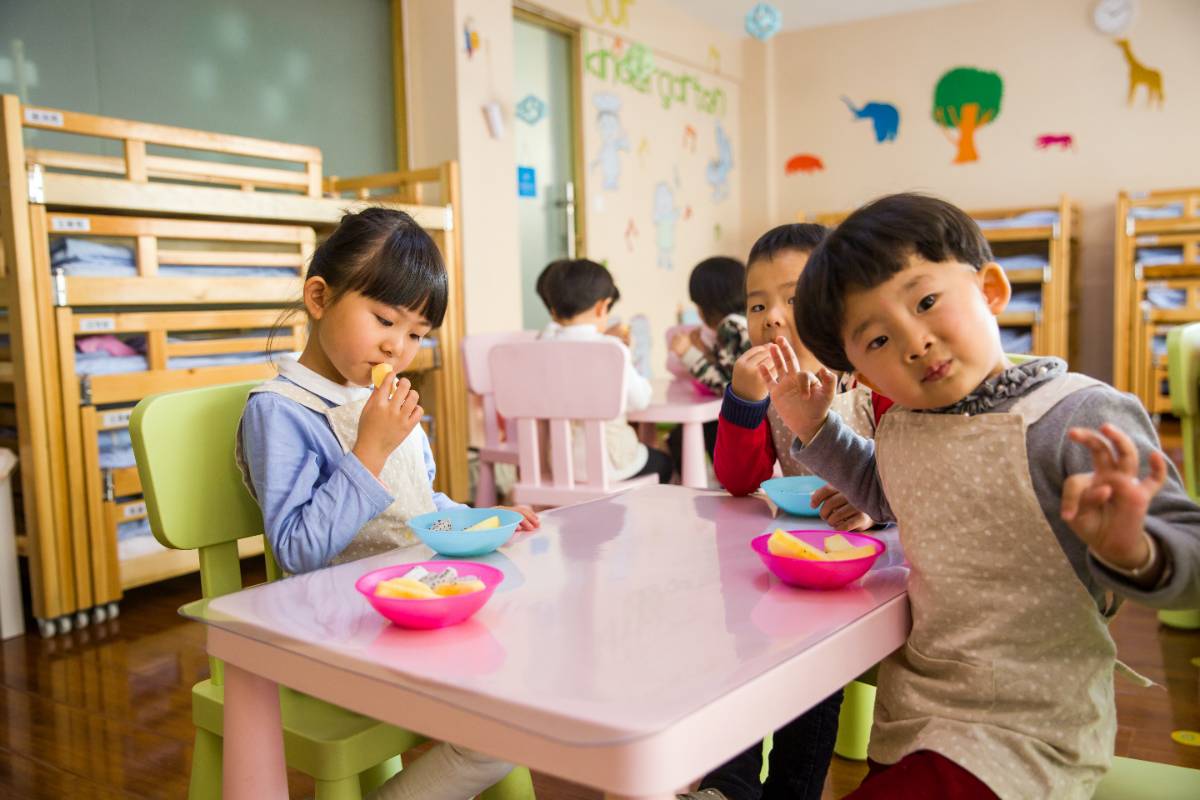 three children eating at a table