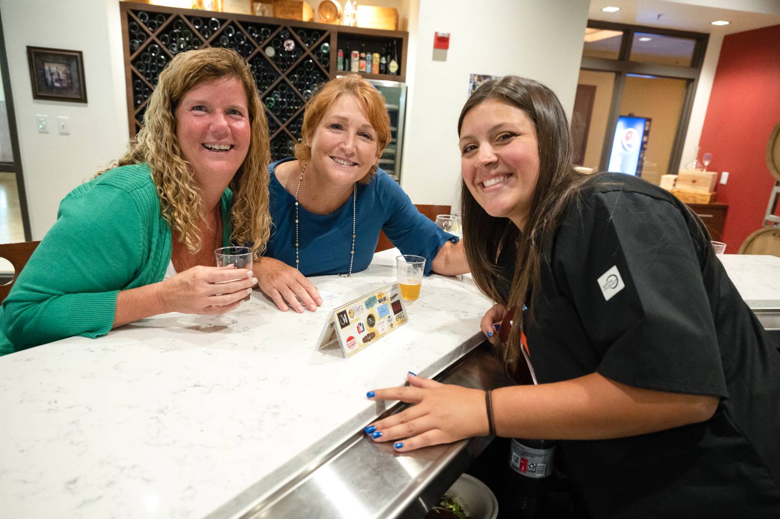 Bartender and two guests at the bar.