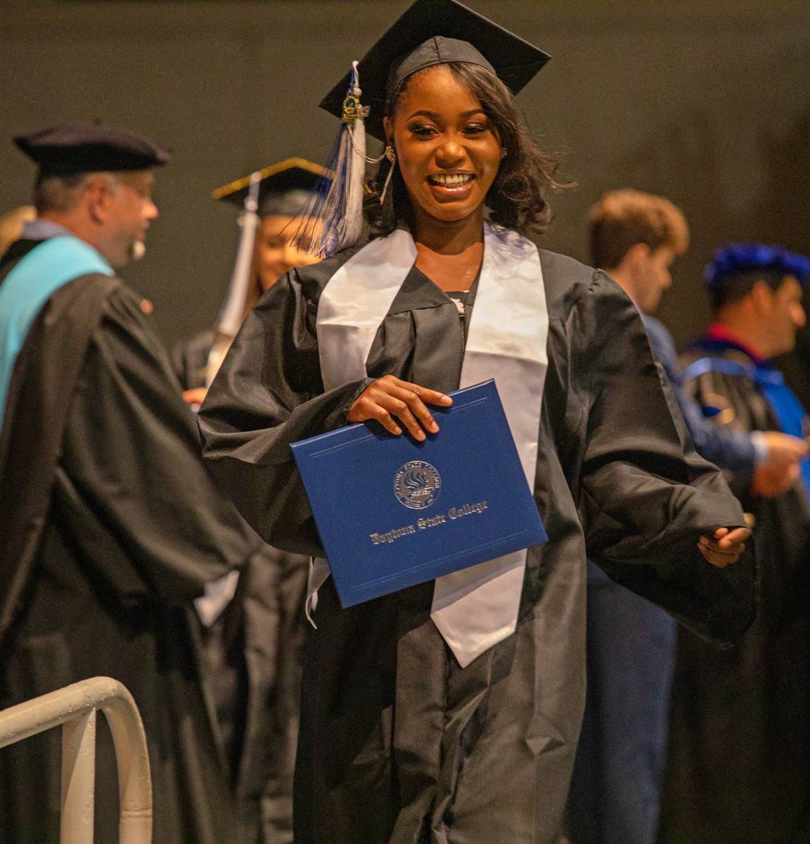 student at graduation with diploma